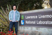 Thomas stands by the LLNL entrance sign