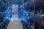 stylized brain image superimposed over wires connecting supercomputer racks