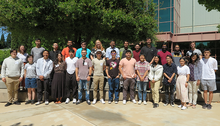 students and mentors pose in a group outside NIF
