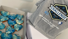 a box of donuts with "DSC" in icing, next to a DSC t-shirt