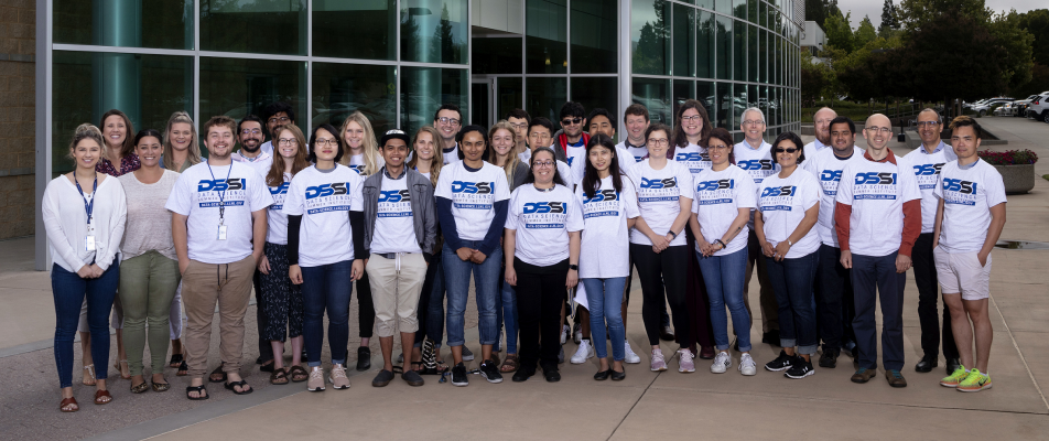 a group of 32 students and mentors stand outside the supercomputing building