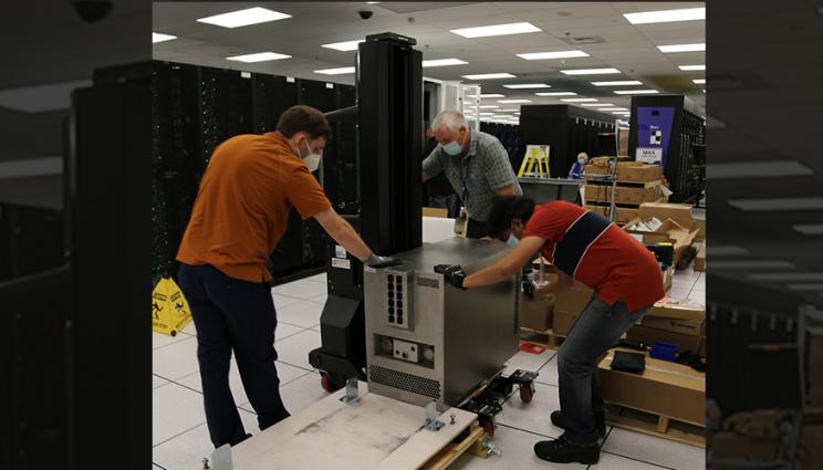 three people install Cerebras components in the HPC machine room