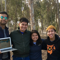 Four UCSD students smile at the camera